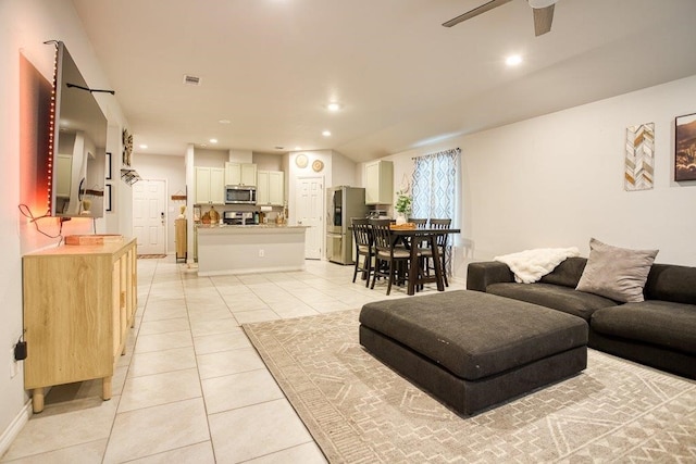 living area featuring recessed lighting, light tile patterned floors, a ceiling fan, visible vents, and baseboards
