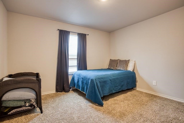 bedroom with baseboards and carpet