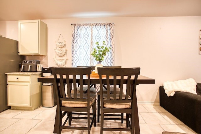 dining area featuring light tile patterned floors