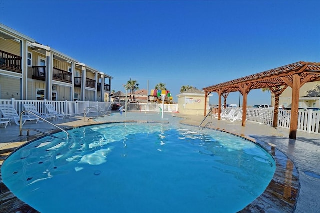 pool with a patio and fence