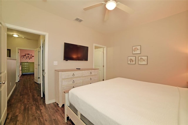 bedroom featuring dark wood-type flooring, a ceiling fan, visible vents, and baseboards