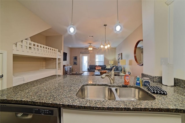 kitchen with dark stone countertops, ceiling fan, a sink, stainless steel dishwasher, and open floor plan