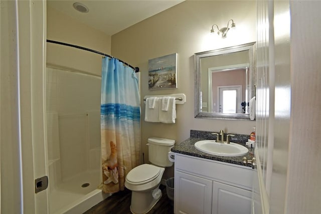 full bath featuring a shower stall, toilet, and vanity