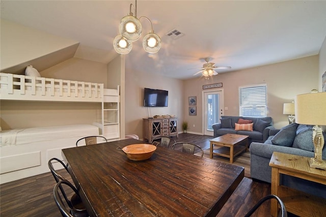 dining area with visible vents, a ceiling fan, wood finished floors, baseboards, and vaulted ceiling