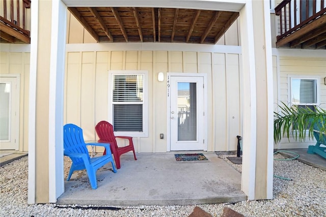 view of exterior entry with board and batten siding