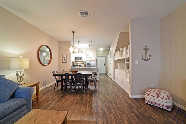 dining room featuring visible vents, baseboards, and dark wood-style flooring