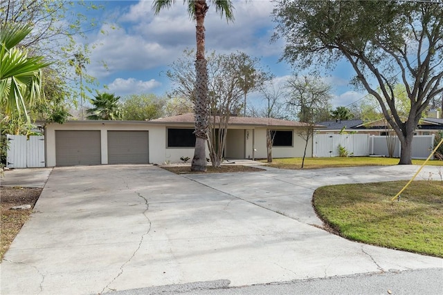 ranch-style home featuring a garage and a front yard