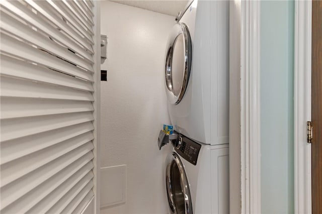 washroom with stacked washer / dryer and laundry area