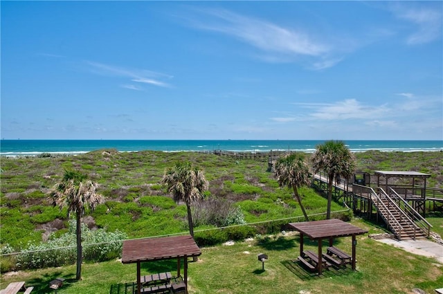 surrounding community with a beach view and a water view