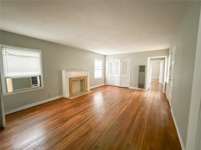 250 Rosebud Ave, Corpus Christi, TX 78404 - unfurnished living room with wood finished floors, cooling unit, and a fireplace