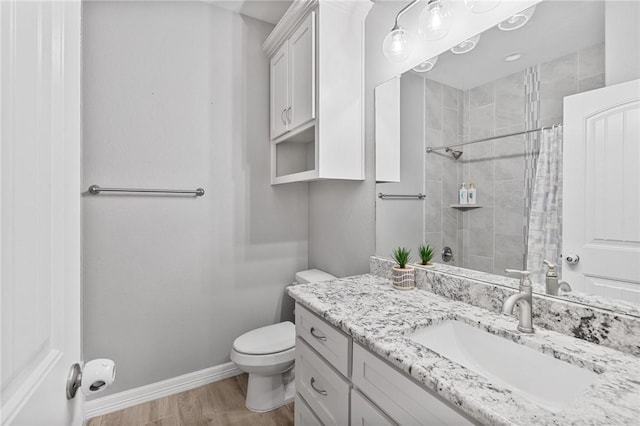4229 Midlands St, Corpus Christi, TX 78414 - bathroom with toilet, tiled shower, wood finished floors, vanity, and baseboards