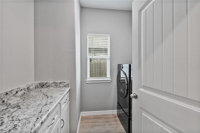 4229 Midlands St, Corpus Christi, TX 78414 - laundry area with cabinet space, light wood-style flooring, baseboards, and washer / clothes dryer