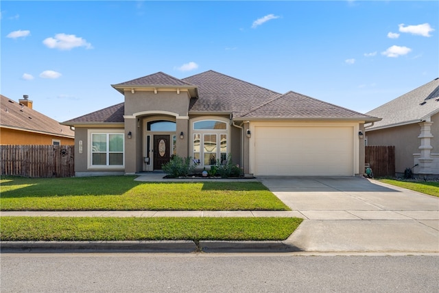 view of front of property featuring a garage and a front yard