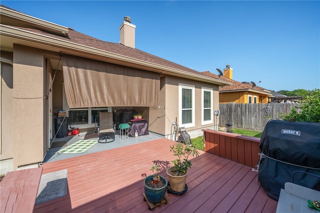 wooden terrace with a grill