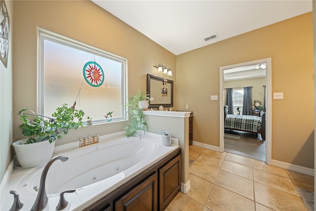 bathroom featuring a washtub, vanity, and tile patterned floors