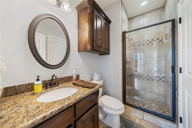 bathroom with toilet, vanity, and an enclosed shower