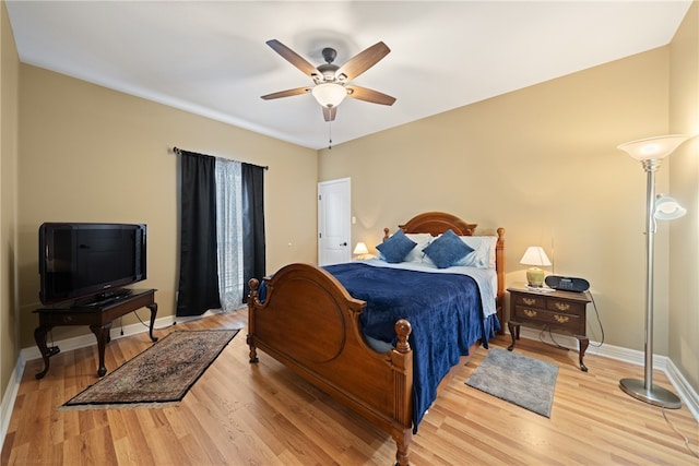 bedroom with ceiling fan and light hardwood / wood-style floors