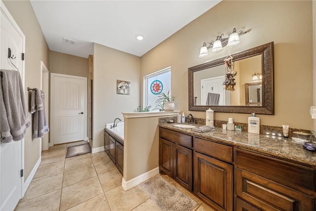 bathroom featuring tile patterned flooring, a bathtub, and vanity