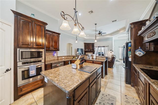 kitchen with black appliances, pendant lighting, light tile patterned floors, and light stone countertops