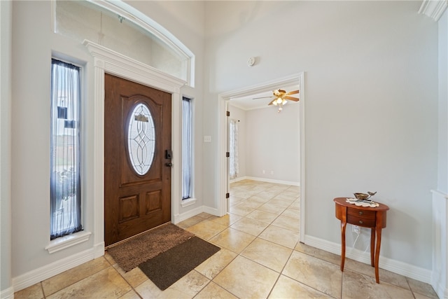 foyer entrance featuring light tile patterned flooring and ceiling fan