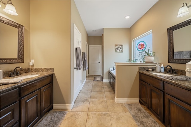 bathroom featuring tile patterned flooring, vanity, and a bathing tub