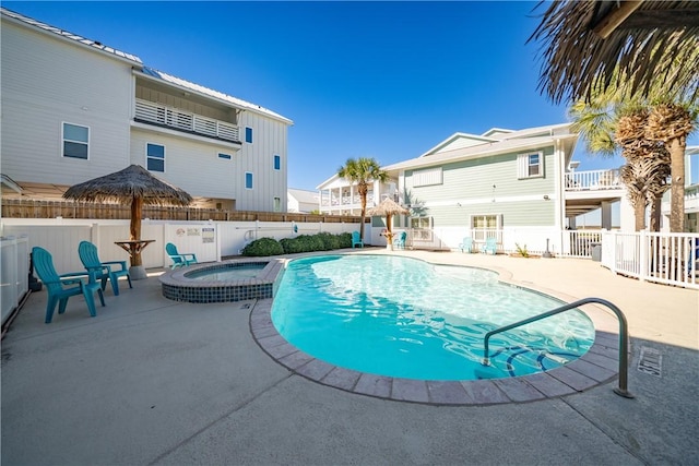 view of pool with a patio area and a community hot tub