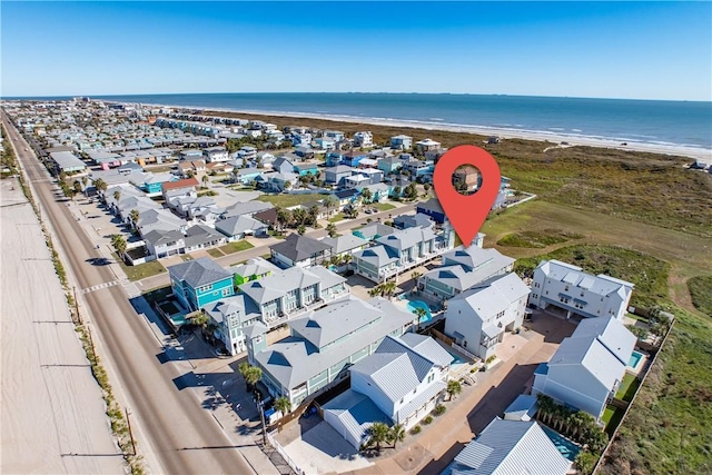 bird's eye view featuring a water view and a view of the beach