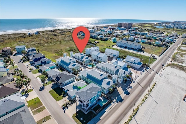 drone / aerial view with a water view and a view of the beach