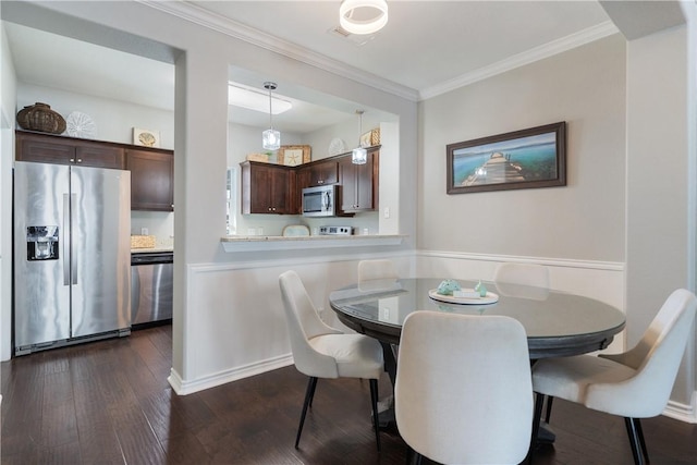 dining room featuring ornamental molding and dark wood-type flooring