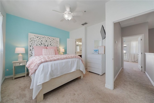 bedroom with connected bathroom, ceiling fan, washer / clothes dryer, and light carpet