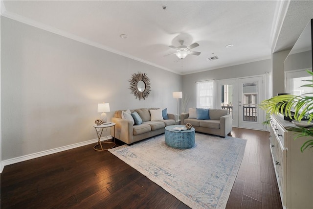 living room with dark hardwood / wood-style floors, ceiling fan, and ornamental molding