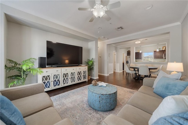 living room featuring hardwood / wood-style flooring, ceiling fan, and ornamental molding