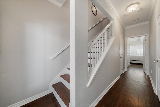 staircase with ornamental molding and hardwood / wood-style flooring