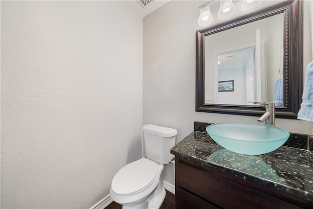 bathroom featuring vanity and toilet