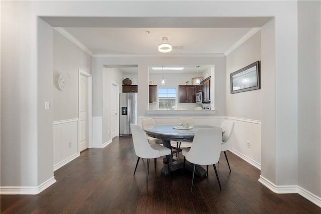 dining area with crown molding and dark wood-type flooring