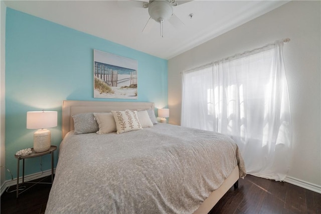 bedroom with ceiling fan and dark hardwood / wood-style floors