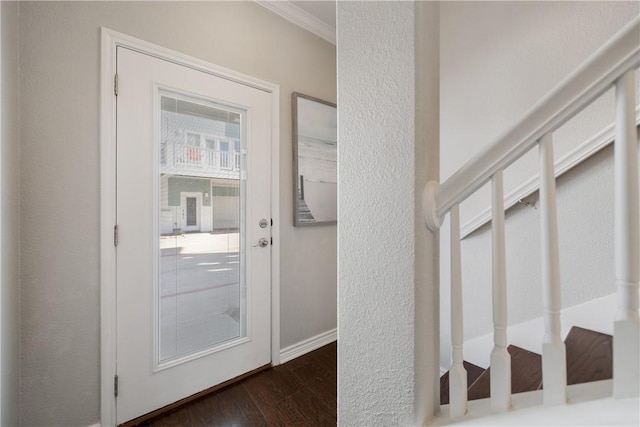 doorway to outside with dark hardwood / wood-style flooring and ornamental molding