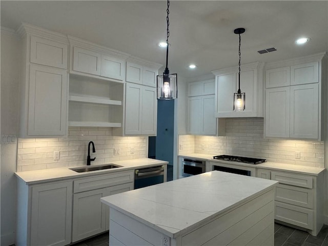 8038 Etienne Dr, Corpus Christi, TX 78414 - kitchen with a center island, dishwashing machine, backsplash, gas stovetop, and light countertops