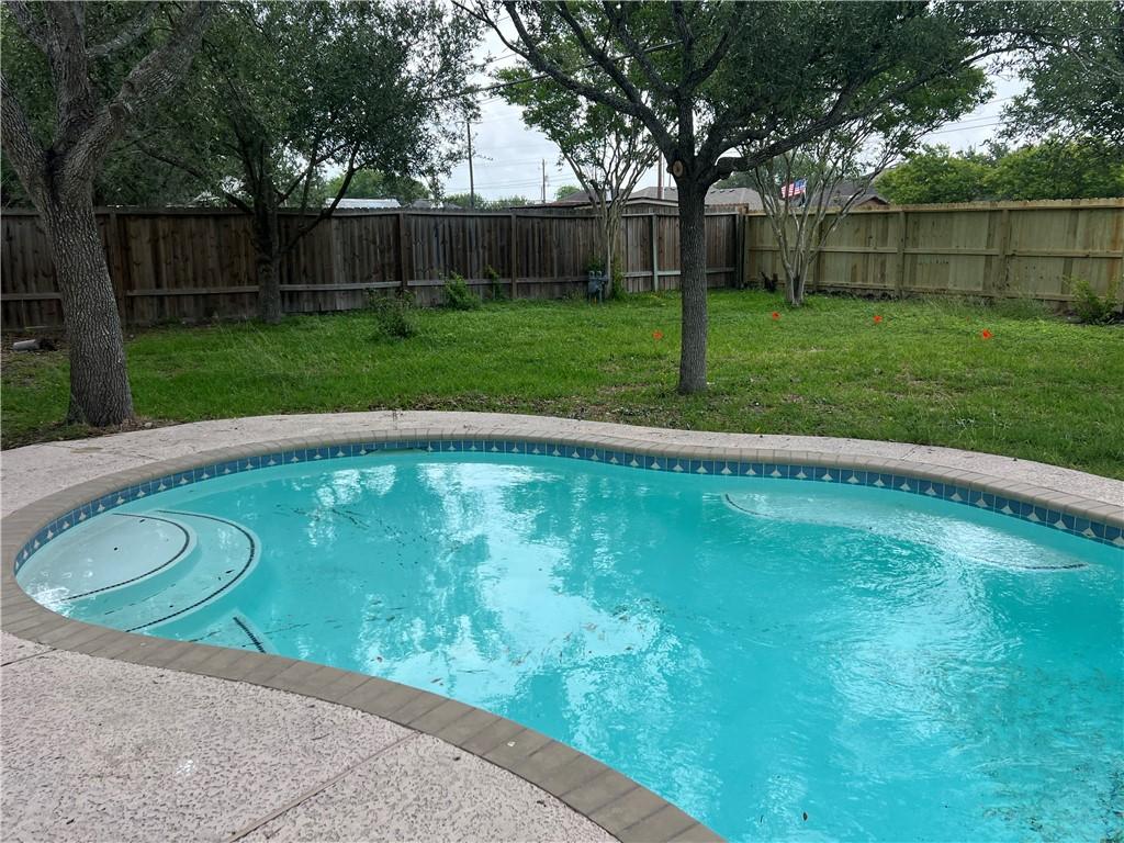 view of pool featuring a yard, a fenced in pool, and a fenced backyard