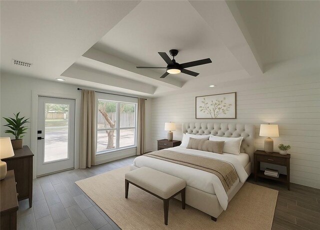 8038 Etienne Dr, Corpus Christi, TX 78414 - bedroom with a tray ceiling, wood finished floors, access to exterior, a ceiling fan, and recessed lighting