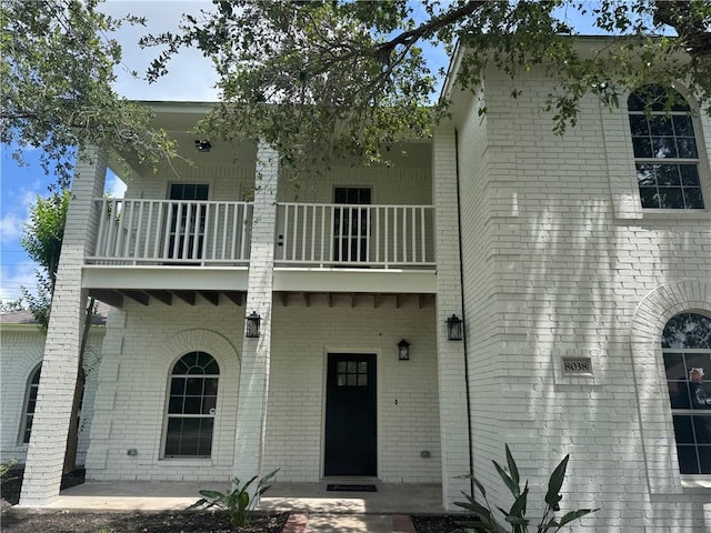 8038 Etienne Dr, Corpus Christi, TX 78414 - rear view of house featuring a balcony and brick siding
