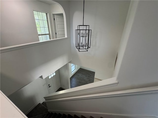 8038 Etienne Dr, Corpus Christi, TX 78414 - stairway featuring healthy amount of natural light, a chandelier, and arched walkways