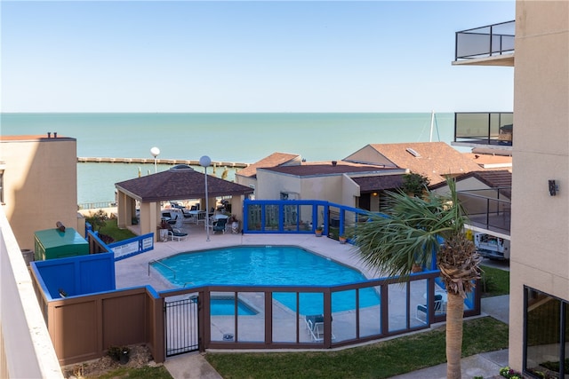 view of pool with a gazebo, a water view, and a patio area