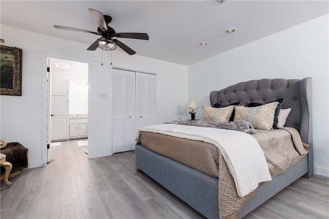 bedroom featuring a closet, light hardwood / wood-style floors, and ceiling fan