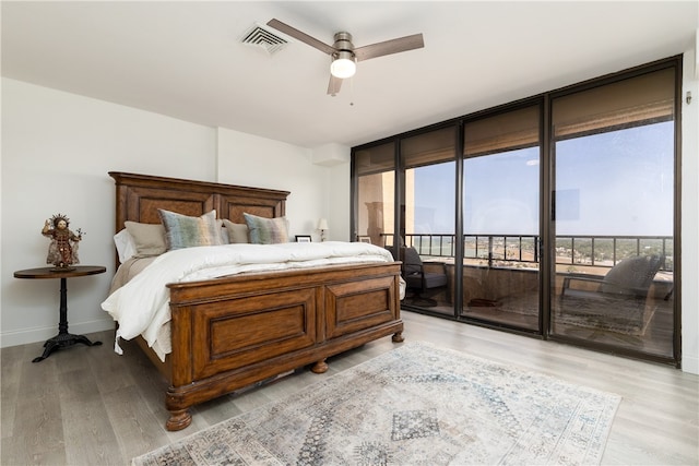 bedroom with ceiling fan, access to exterior, and light wood-type flooring