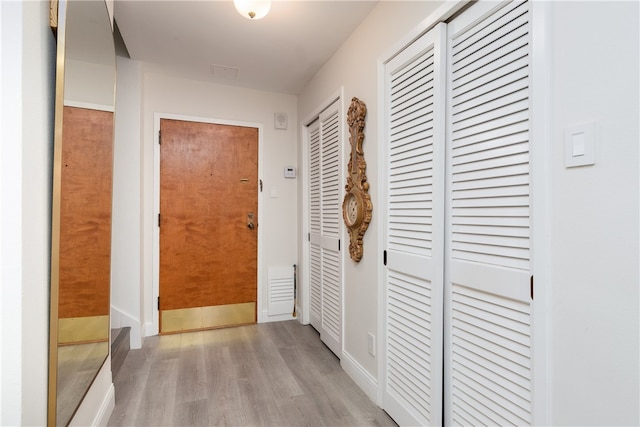 hallway with light hardwood / wood-style flooring