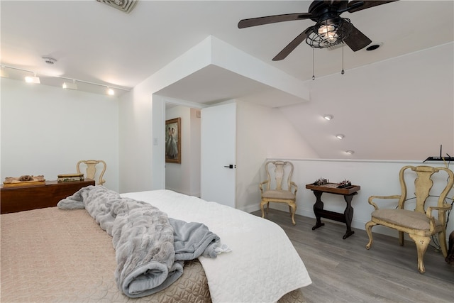 bedroom with hardwood / wood-style flooring, ceiling fan, and vaulted ceiling