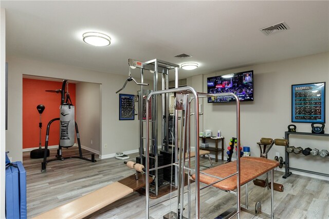 workout room with light hardwood / wood-style floors