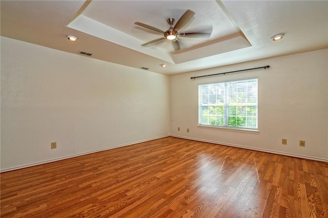 5372 County Road 73a, Robstown, TX 78380 - spare room with a tray ceiling, wood finished floors, ceiling fan, and recessed lighting