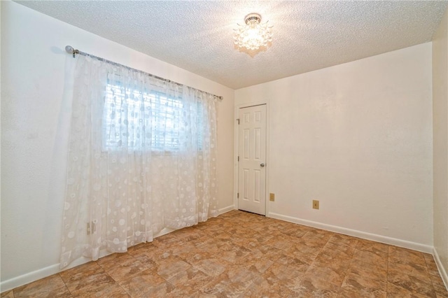 5372 County Road 73a, Robstown, TX 78380 - unfurnished room featuring baseboards and a textured ceiling